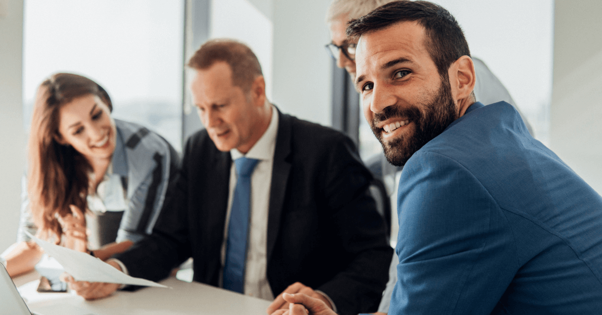 an ISO auditor with clients around a table