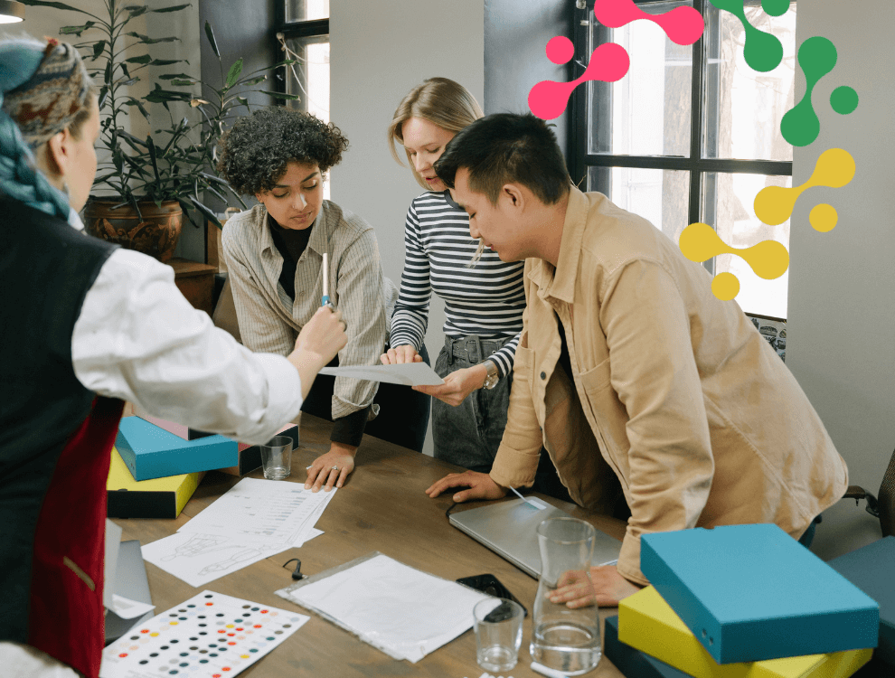 CSC2-ISO-22301-Business-Continuity-Management.2 a group of people standing around a table in an office